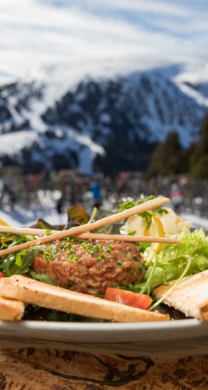 Beef & Snow Mayrl Alm | © Günther Pichler Rindstatar mit Blick auf Skipisten Obereggen und Zanggen | © Günther Pichler